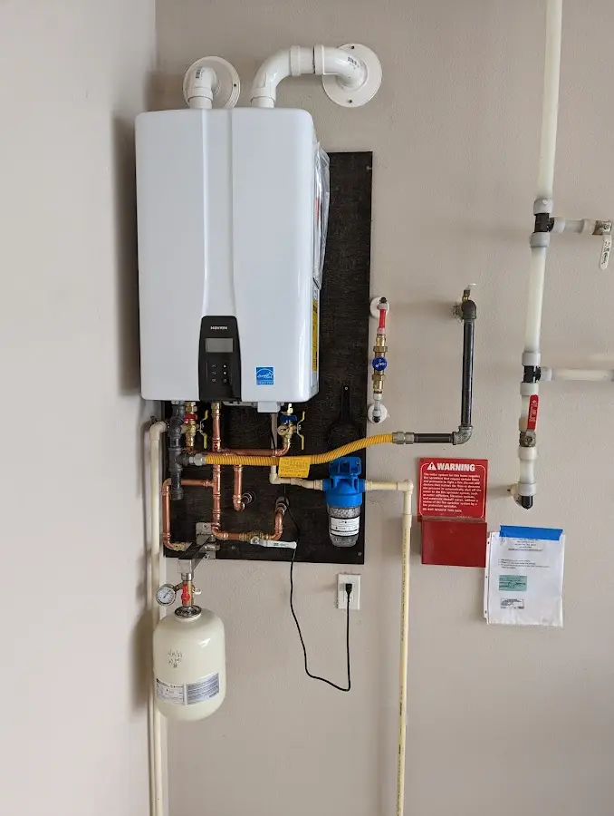 Professional plumber installing copper piping in a Harlingen home